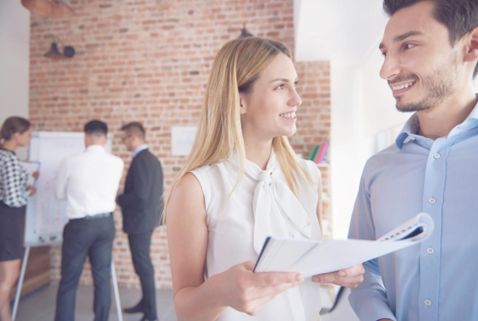 Business meeting with laptop showing financial charts and lending options comparison