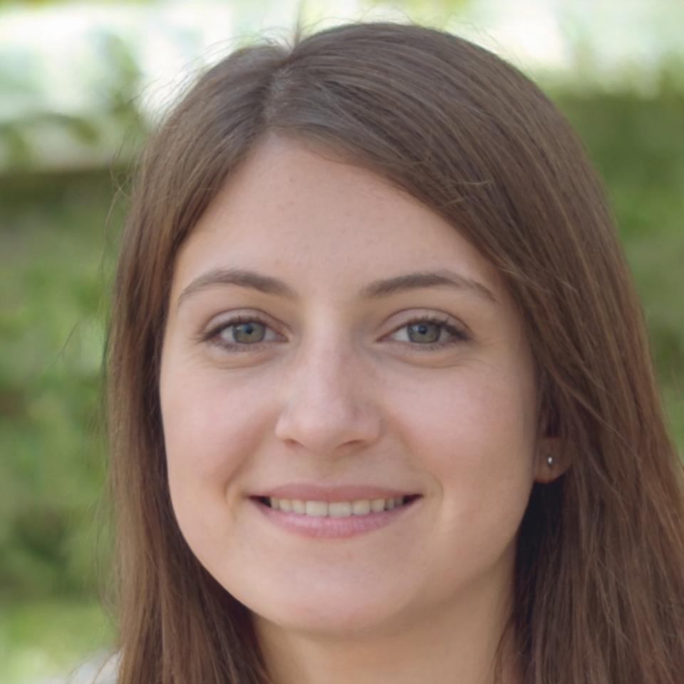 Professional headshot of Elena Kowalski smiling in business attire